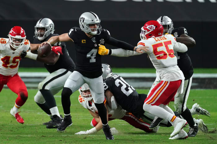 Nov 22, 2020; Paradise, Nevada, USA; Las Vegas Raiders quarterback Derek Carr (4) moves the ball against Kansas City Chiefs defensive end Frank Clark (55) during the first half at Allegiant Stadium. Mandatory Credit: Kirby Lee-USA TODAY Sports